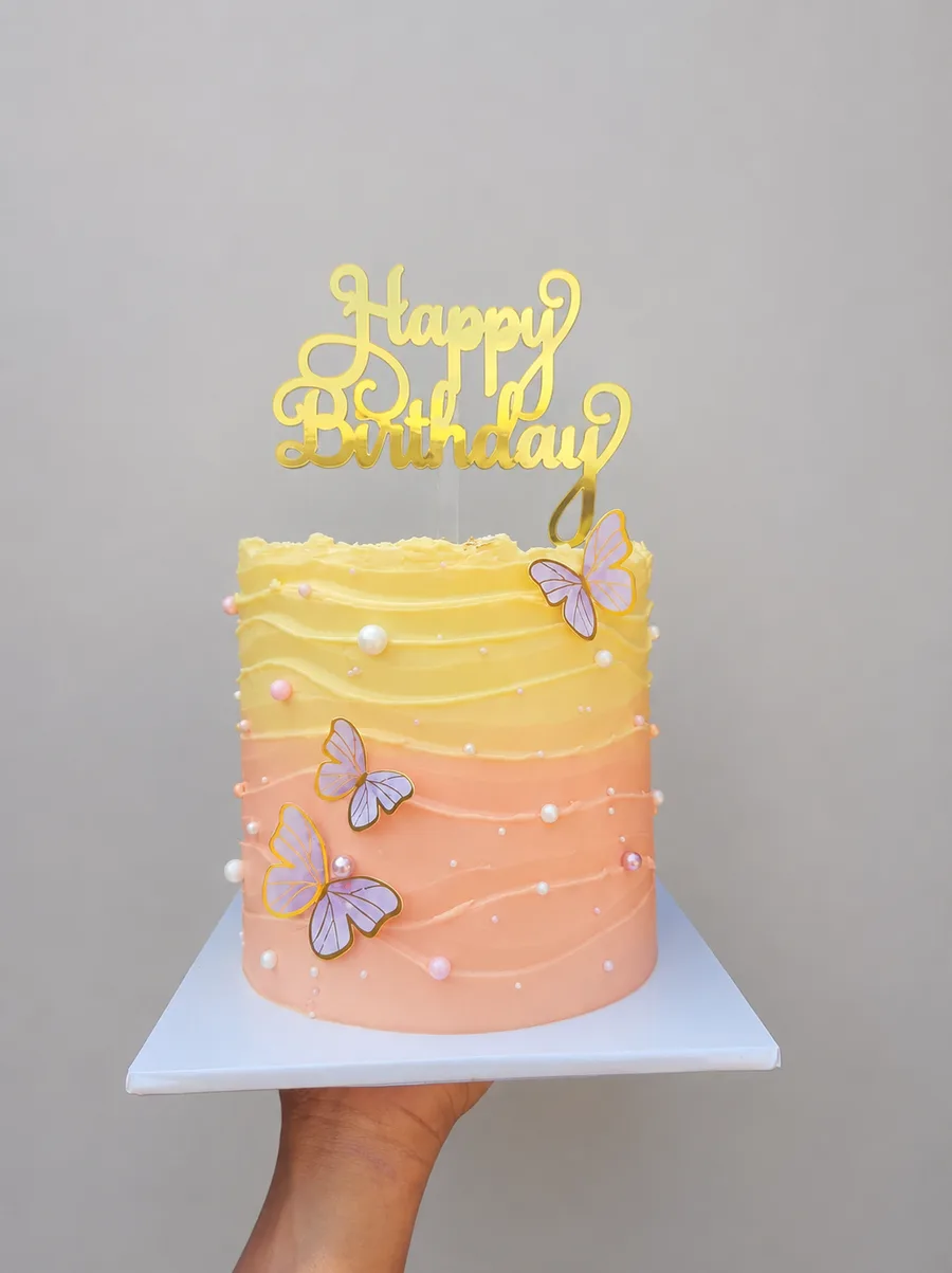 A peach and yellow birthday cake Tonnie baked